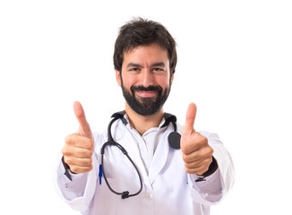 Doctor with thumbs up over white background