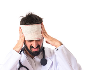 Doctor with headache over white background