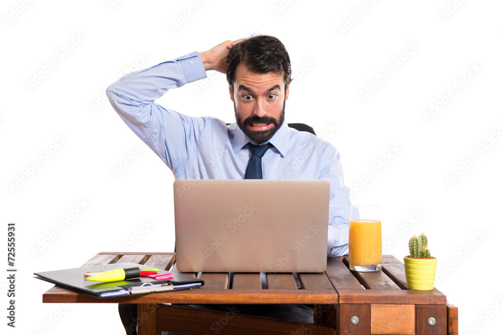 Wall mural businessman in his office having doubts