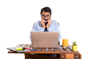 Frightened businessman over white background