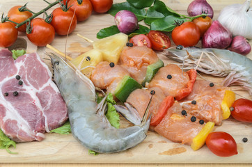 Fresh meat ,seafood  and vegetables on kitchen board