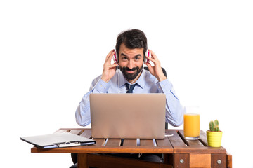 Businessman in his office listening music