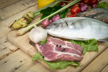 Fresh meat ,seafood  and vegetables on kitchen board