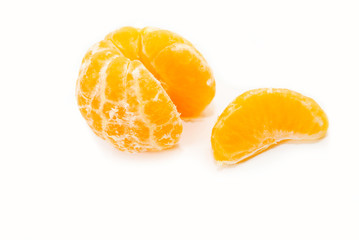 An Orange Slice Next to a Peeled Orange