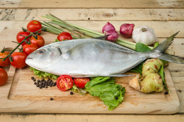 fish and vegetables on kitchen board