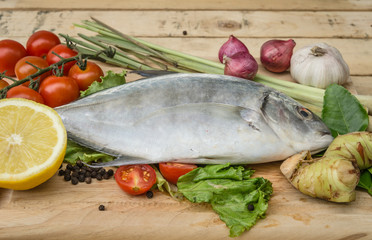 fish and vegetables on kitchen board