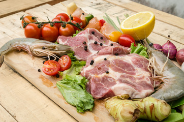 Fresh meat ,seafood  and vegetables on kitchen board