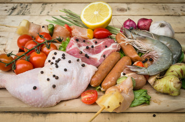 Fresh meat ,seafood  and vegetables on kitchen board