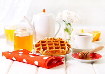 breakfast with waffles, honey and coffee