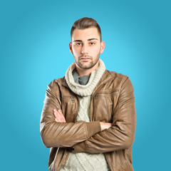 Man with arms crossed over blue background