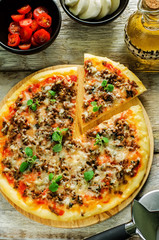 pizza with meat, mozzarella and oregano