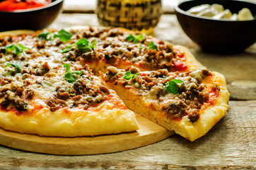 pizza with meat, mozzarella and oregano