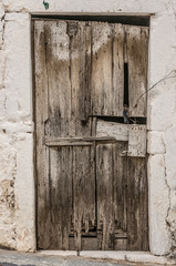 Old timber door in the scuffed wall