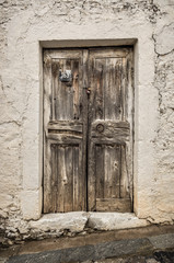 Old timber door in the scuffed wall