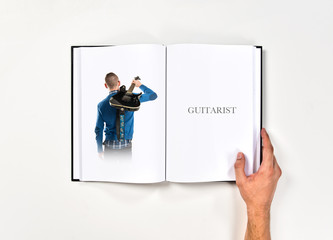 Young man with his guitar printed on book