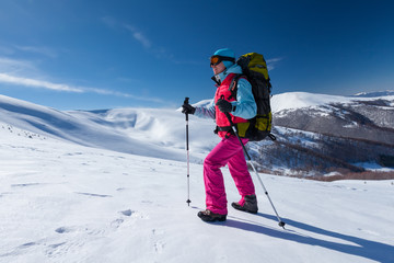 Hiker in winter mountains during sunny day