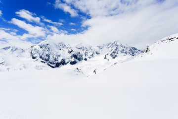 Fototapeta na wymiar Winter mountains, ski run in Italian Alp