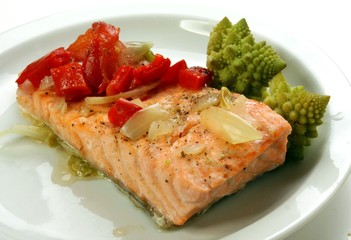 steamed salmon, green cauliflower on a white plate