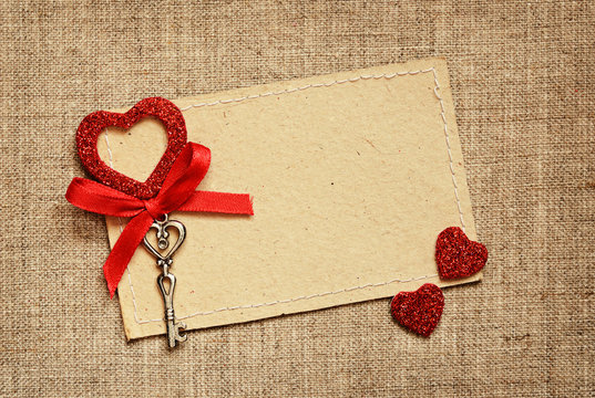 Greeting card with red ribbon and a key for Valentine's day