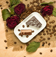 dry red roses and cookies on coffee seeds