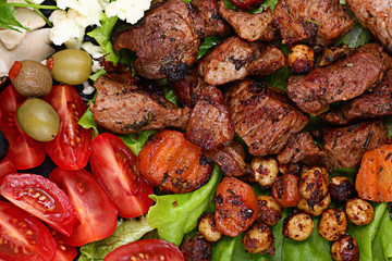 grilled meat on a plate served with vegetables