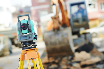 Surveyor equipment at construction site - obrazy, fototapety, plakaty