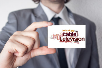 Cable television. Businessman in suit with a black tie showing o