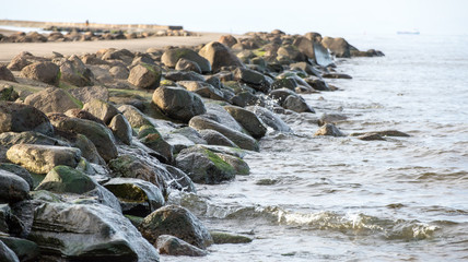 breakwater in the sea with lighthouse on it
