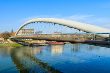 Fototapeta na wymiar Bernatka bridge over Vistula river on sunny day, Krakow, Poland