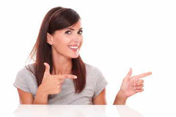 Hispanic woman pointing to her left