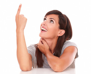 Charming brunette pointing up and looking up
