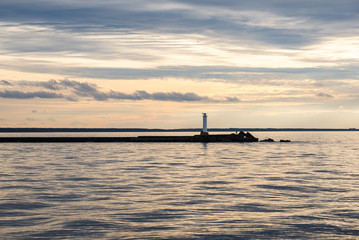 breakwater in the sea with lighthouse on it