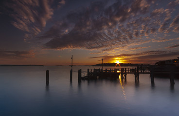 Obraz premium Sunset over a jetty near Brownsea Island in Poole Harbour