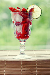 fresh strawberries in a cocktail glass with ice
