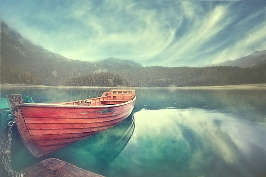 wooden boat on a mooring mountain lake