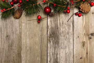 Aged wood Christmas background with branch and bauble top border