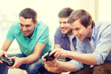 smiling friends playing video games at home