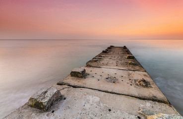 Stone jetty and calm seas