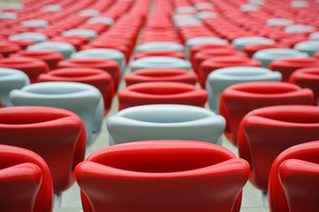 Several rows of red and white stadium seats