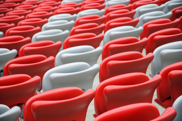 Naklejka premium Several rows of red and white stadium seats