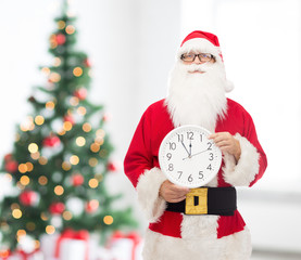 man in costume of santa claus with clock