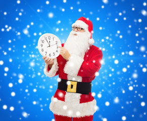man in costume of santa claus with clock