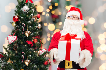man in costume of santa claus with gift box