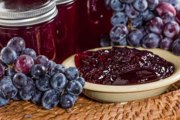 Grapes and bowl of grape jelly