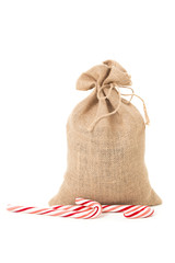 Burlap sack with Christmas candy canes. 