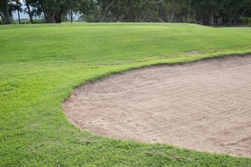 sand bunker and green grass of golf course