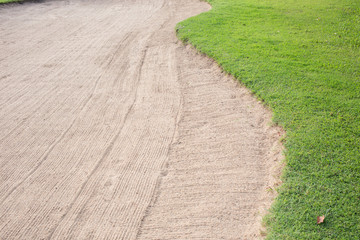 sand bunker and green grass of golf course