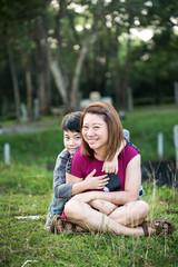 Fototapeta premium Son hugging mother Asian family