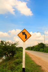 Winding road sign on blue sky