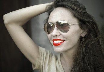 Monochrome portrait of young beautiful woman with red lipstick